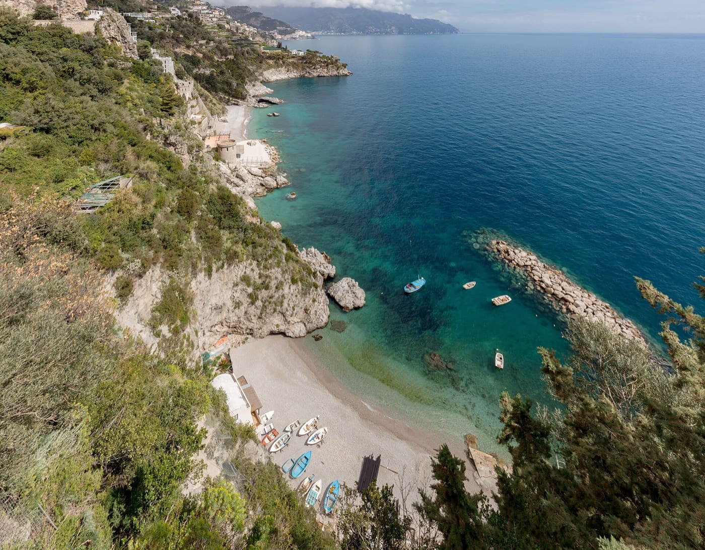 The cove of Conca dei Marini from above, boats on clear water