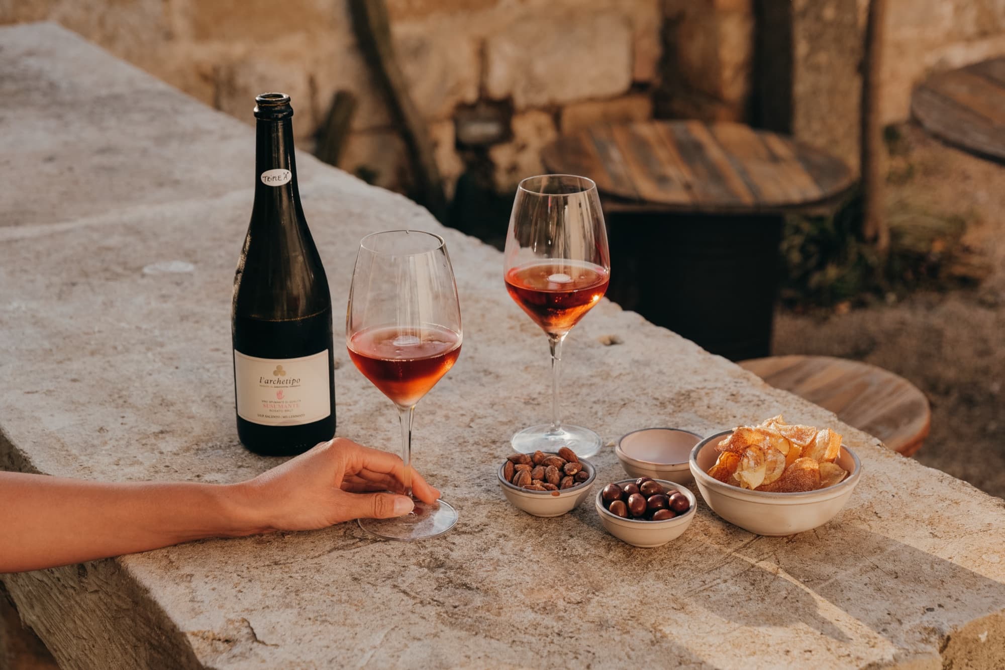 Wine and small plates on a stone table in the courtyard