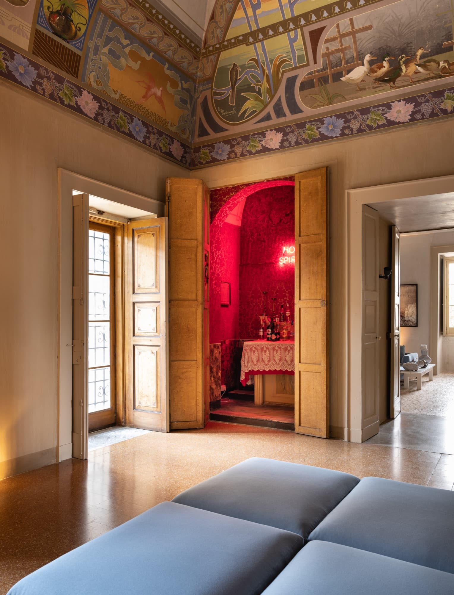 Frescoed salon opening onto the red dining room