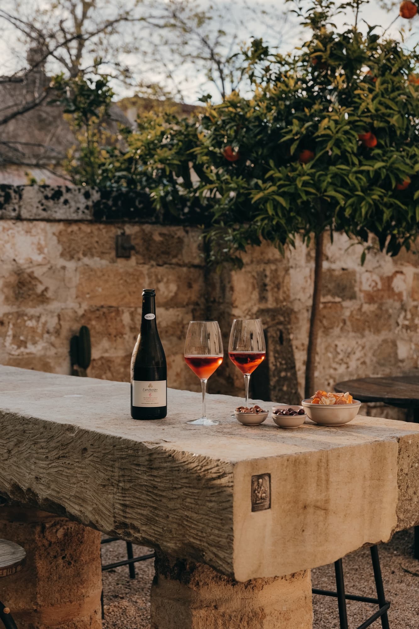 Evening light on the terrace, wine on the parapet